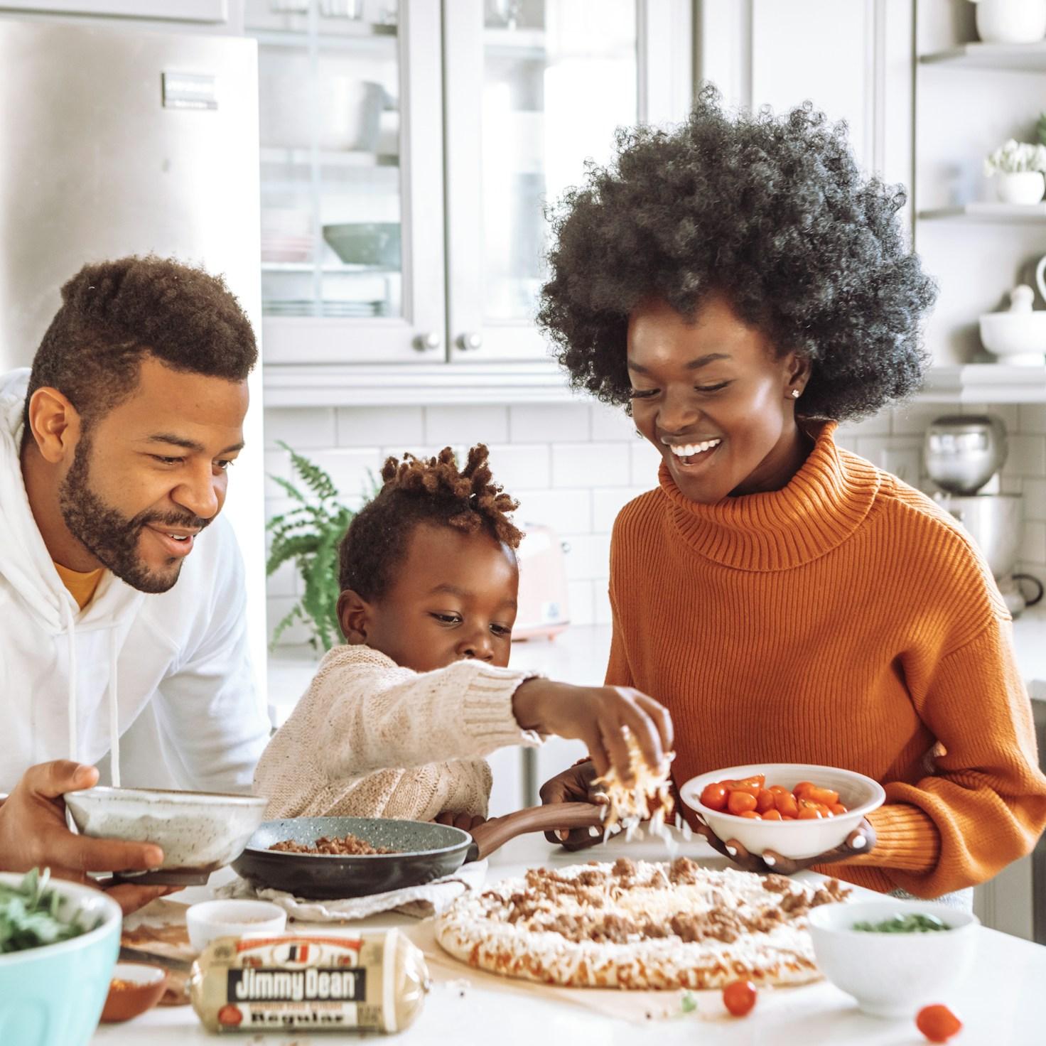 Diverse group of community members sharing a meal together, highlighting the connections built through collaborative cooking