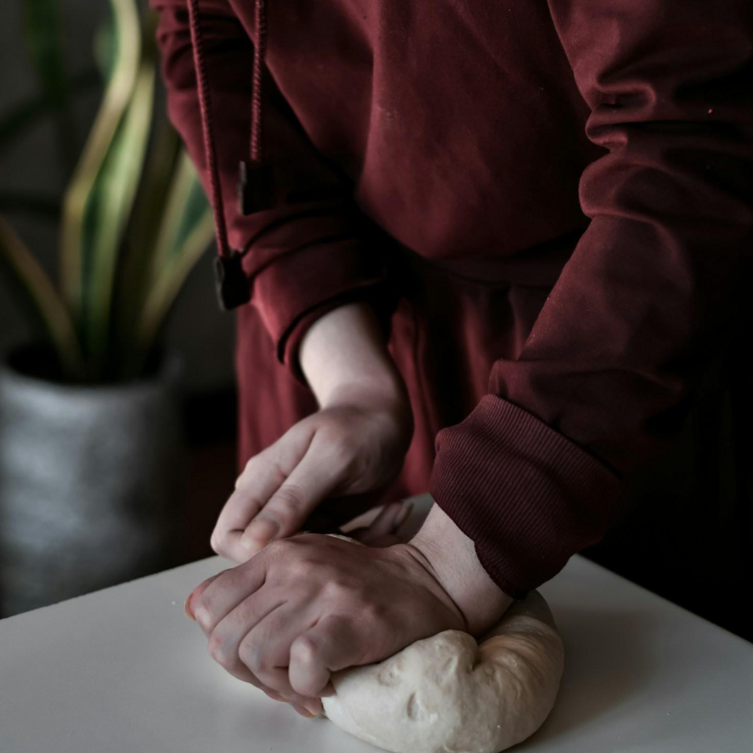Community members collaborating in a contemporary kitchen, exchanging recipes and cooking techniques